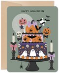 Cute Halloween greeting card featuring a multi-tiered spooky cake decorated with smiling pumpkins, friendly ghosts, bats, spiders, skulls, and candles, set against a full moon on a teal background.