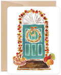 Watercolor illustration of a teal front door adorned with a golden wreath, vibrant autumn leaves, and pumpkins. A festive fall greeting card perfect for the harvest season.