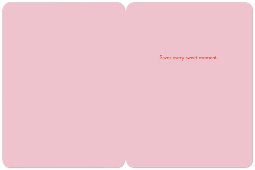 Inside of a pink Christmas greeting card displaying the red text 'Savor every sweet moment.' centered on the light pink background.