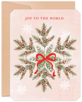 Front of a festive holiday greeting card featuring a watercolor snowflake design made of pine needles, red berries, and pinecones, tied with a red ribbon, on a light pink background with 'JOY TO THE WORLD' text. Includes a brown kraft envelope.