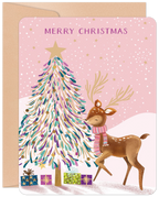 Whimsical pink festive greeting card featuring a reindeer wearing a striped scarf, a gold-starred decorated fir tree, and colorful presents under falling snow, with 'MERRY CHRISTMAS' text.