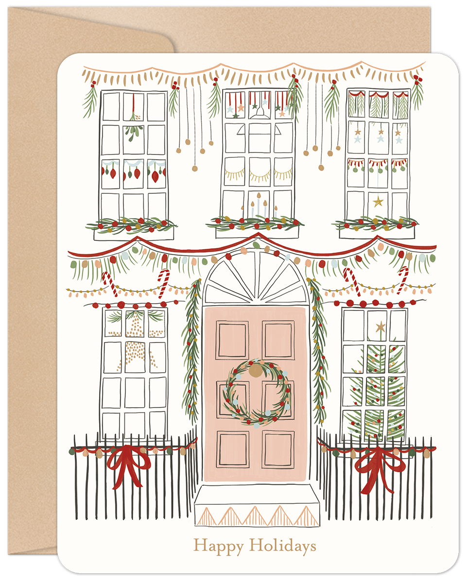 Front of a charming cream-colored holiday card featuring an illustrated house adorned with festive garlands, string lights, ornaments, and red bows, perfect for sending seasonal greetings.