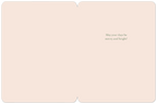 Inside view of an open seasonal greeting card with a soft pink interior, displaying the elegant green script 'May your days be merry and bright!'.