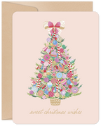 Gourmet candy decorated evergreen tree on a blush pink greeting card with 'sweet christmas wishes' text, perfect for sending season's greetings.