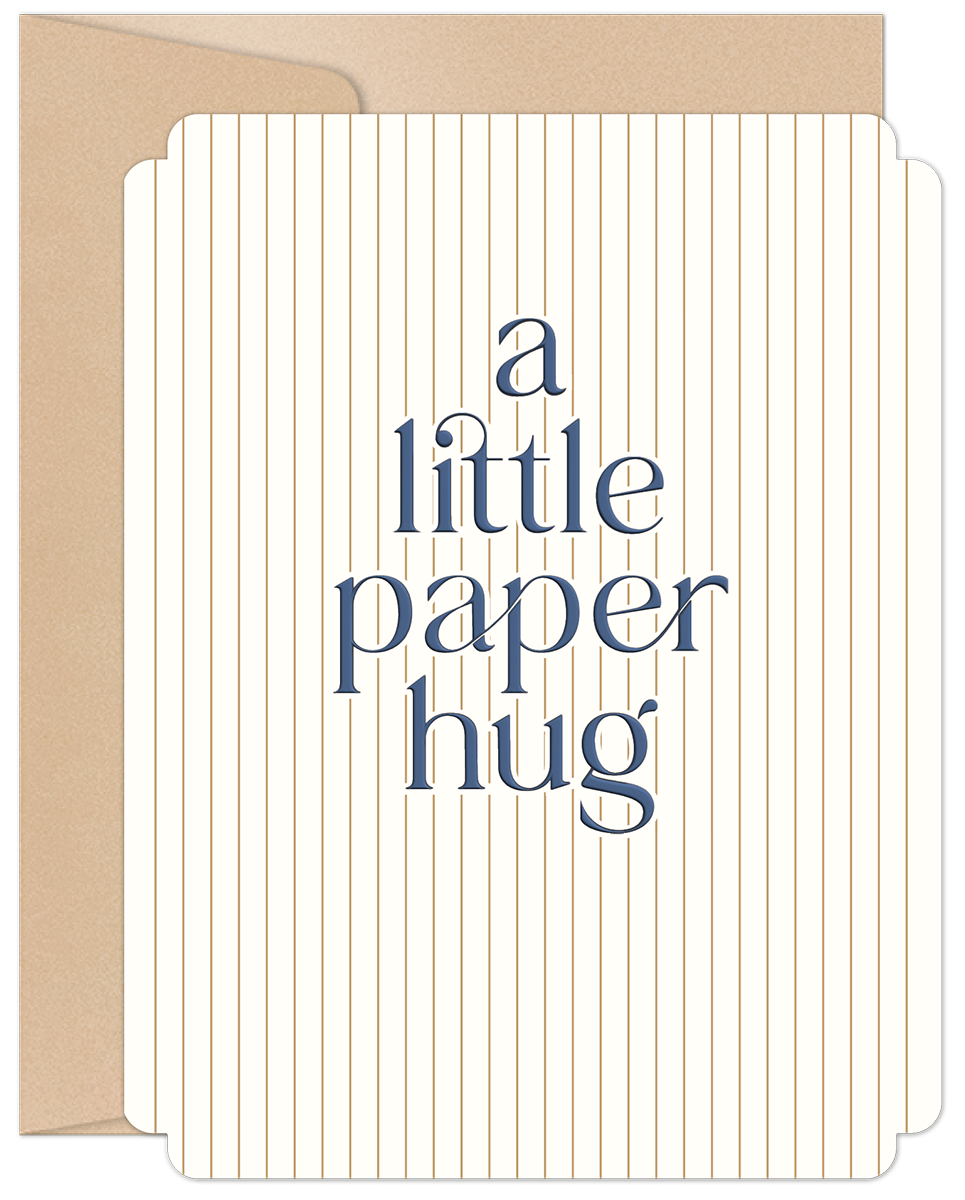 Elegant white greeting card with vertical gold pinstripes and navy text 'a little paper hug', peeking from a kraft brown envelope. Perfect for sending love and comfort.