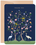 Elegant Thank You greeting card featuring two cranes under blossoming trees, with gold text and a dark blue background on a kraft envelope.