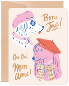 Whimsical greeting card front featuring two charming dogs in berets, one a dalmatian in pink and one a poodle in red, with 'Bone Jour!' and 'Oui Oui, Mon Amie!' text, perfect for dog lovers.