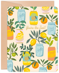 A square greeting card featuring a vibrant pattern of lemons, oranges, and greenery in mason jars and soda cans, with the gold script text "You're the Zest!". A kraft paper envelope is partially visible behind the card.